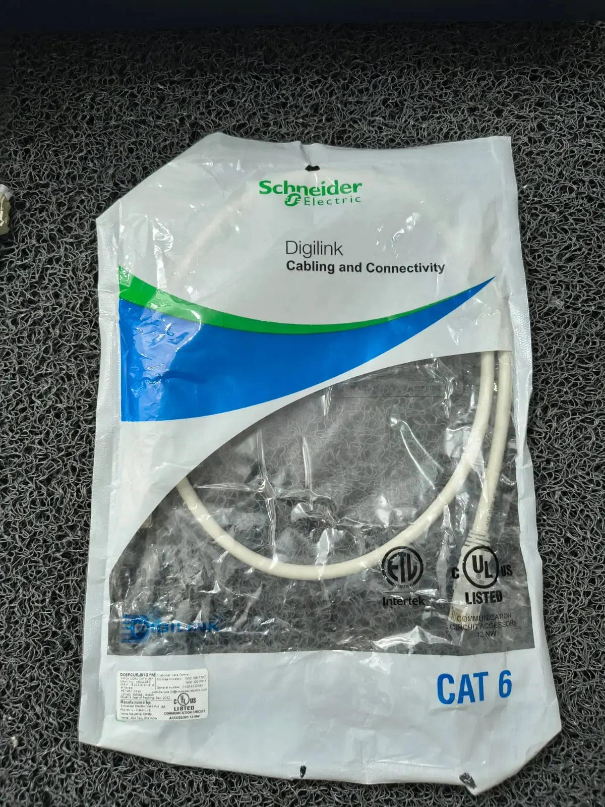 Cat 6 cable in a Schneider Electric packaging on a textured black surface